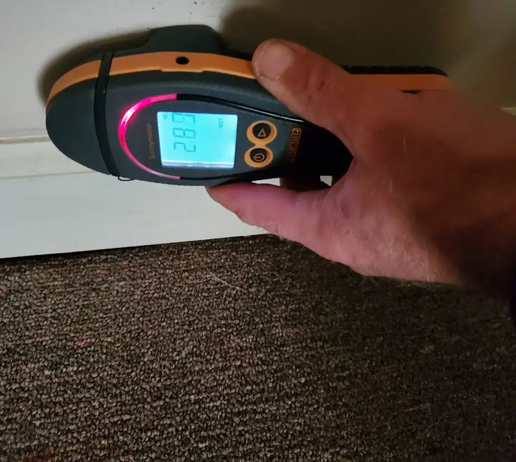 Moisture detection at baseboard during Storm Damage Restoration in Lowell